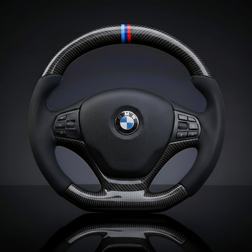 BMW carbon fiber steering wheel with carbon fiber accents on a dark background