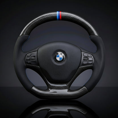 BMW carbon fiber steering wheel with carbon fiber accents on a dark background