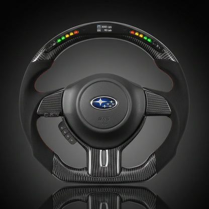 Steering wheel with Subaru logo on a reflective black surface